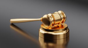 Johns Creek Domestic Violence Defense Attorney Canva Golden Hammer and Gavel 300x165